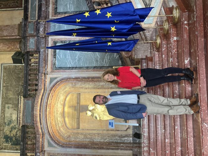 Alec Foster and Emily Parker on the steps in the Royal Palace of Brussels.